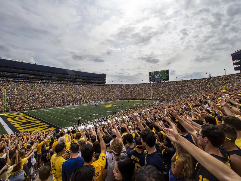 Michigan fans in the student section at a football game